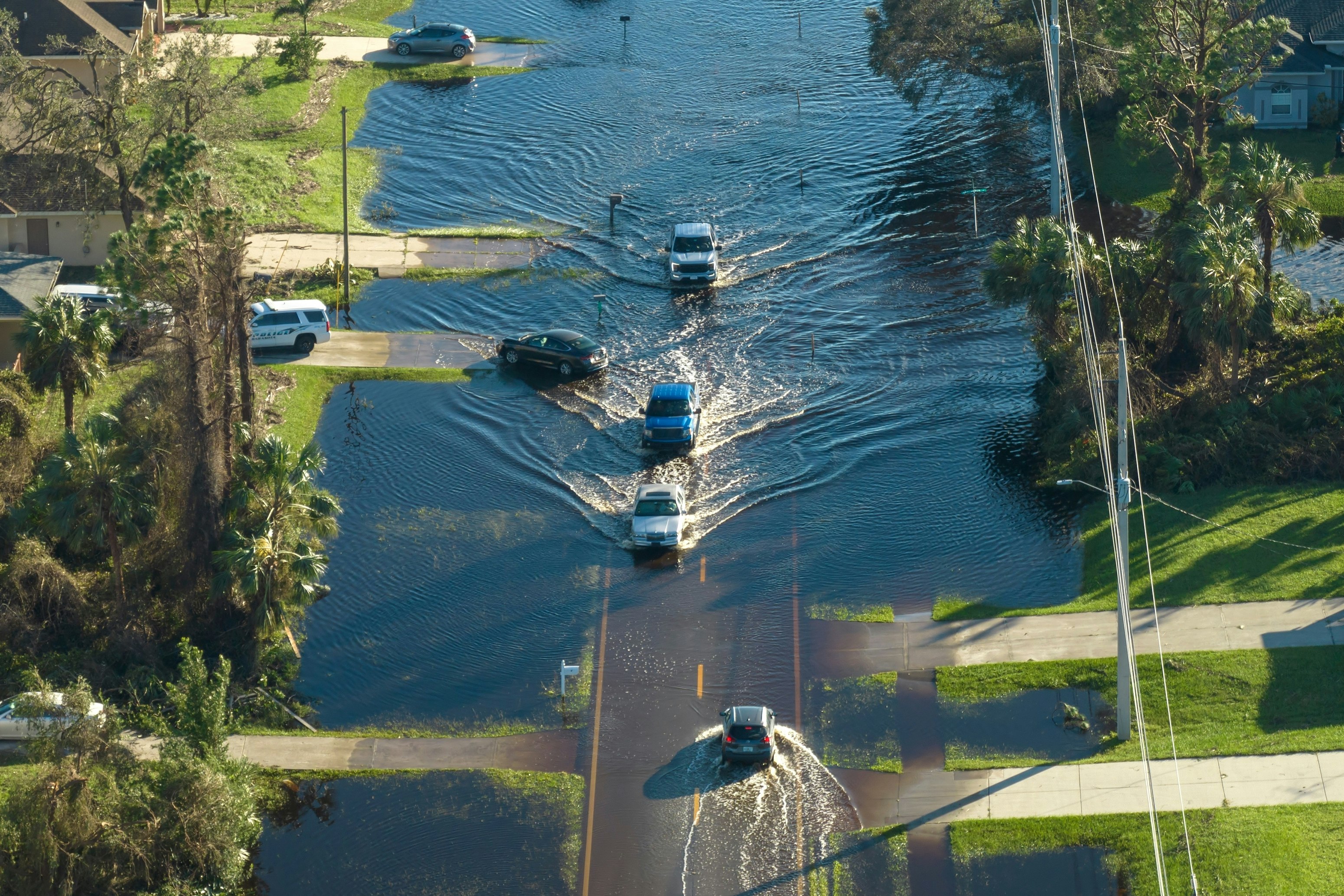 cars driving through flooded road
